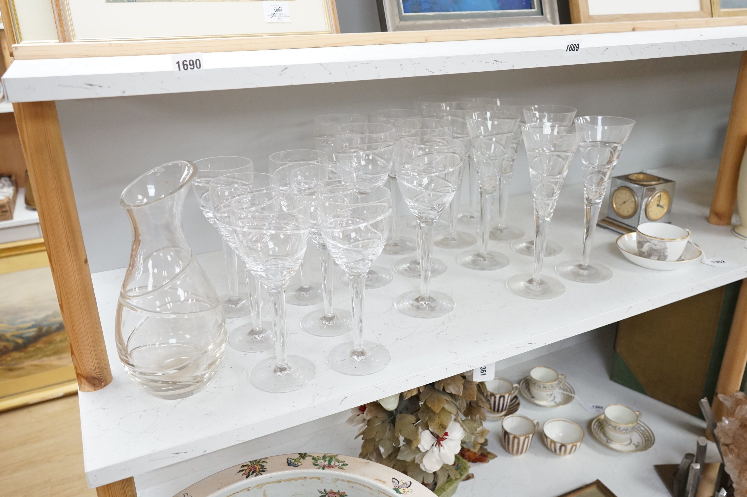 Various part suites of Jasper Conran hand cut Stuart Crystal ‘Aura’ glasses. Including eight Champagne, five large wine and six smaller wine glasses and a carafe, largest 27cm high